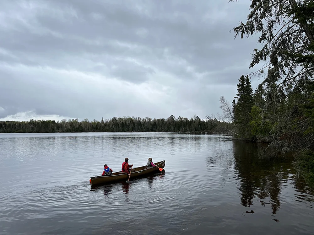 Best Family Canoe - Kids and father paddling kevlar canoe across lake in northern Minnesota