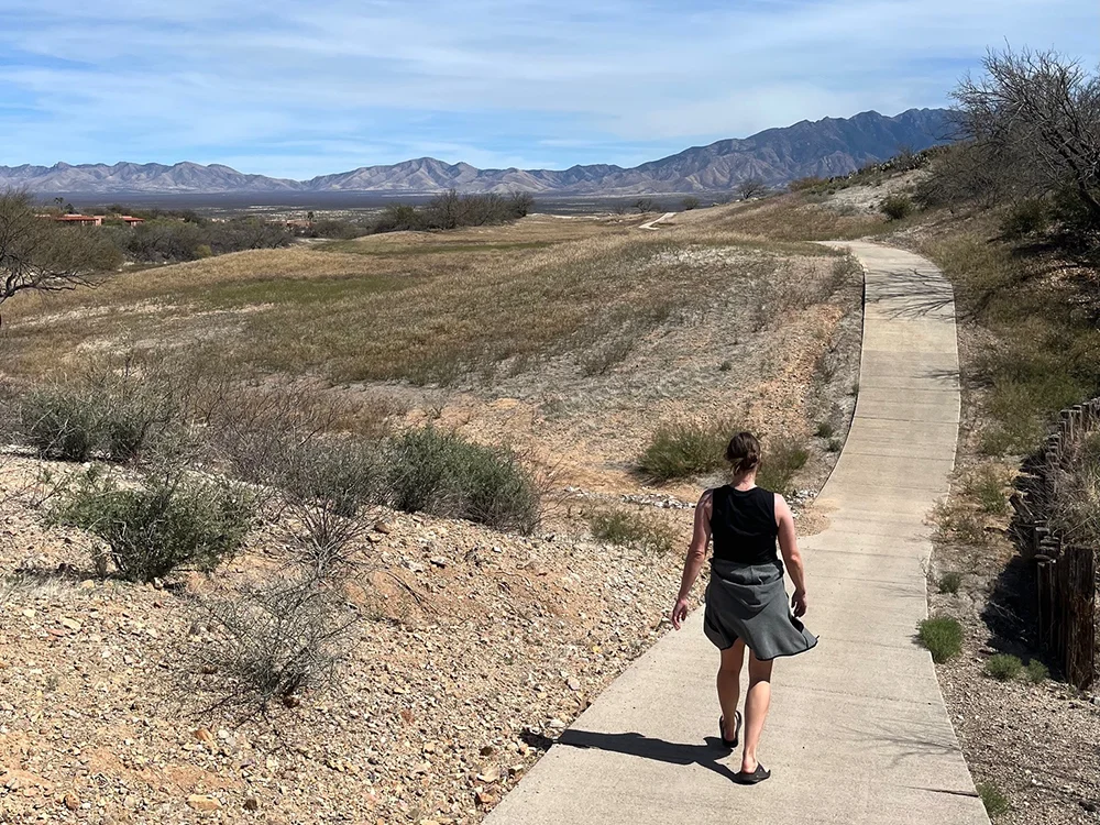 Woman hiking in Canoa Hills Trails Park with beautiful mountains in the background