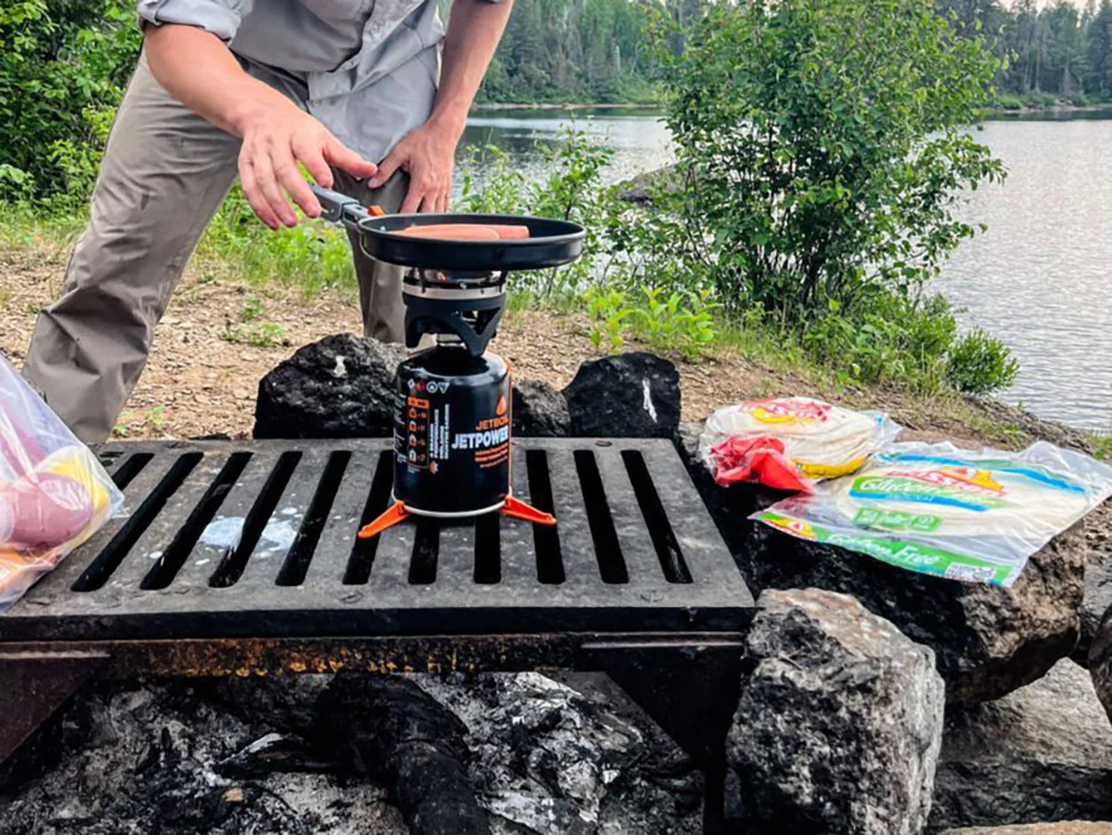 Cooking hotdogs over a Jetboil stove during a fire ban while camping