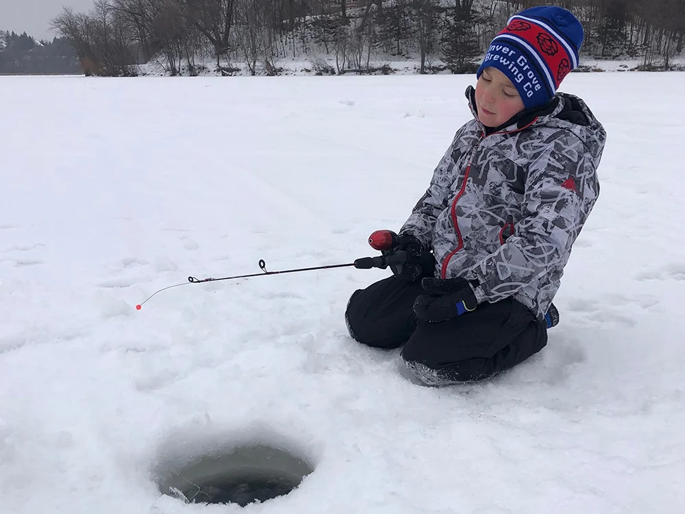 Ice Fishing Trip MN - Kid jigging for panfish