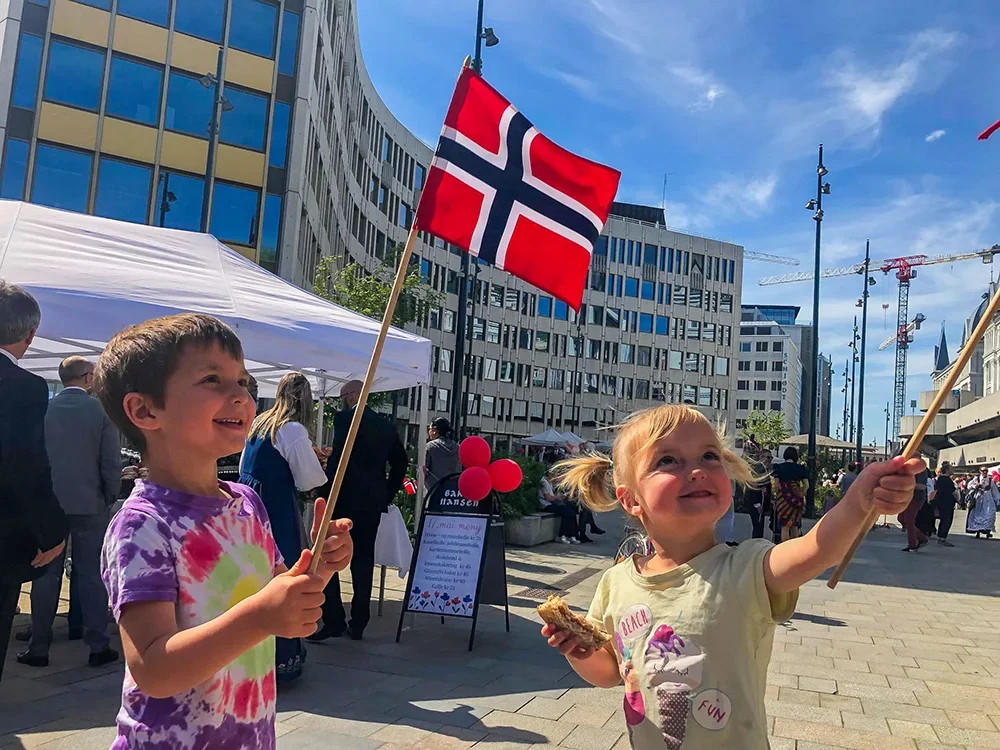 Norway - Kids waving Norwegian flags at the Settende Mai festivities in Oslo